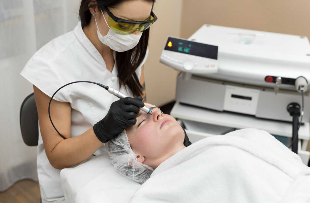 A woman is treated with an IPL device.