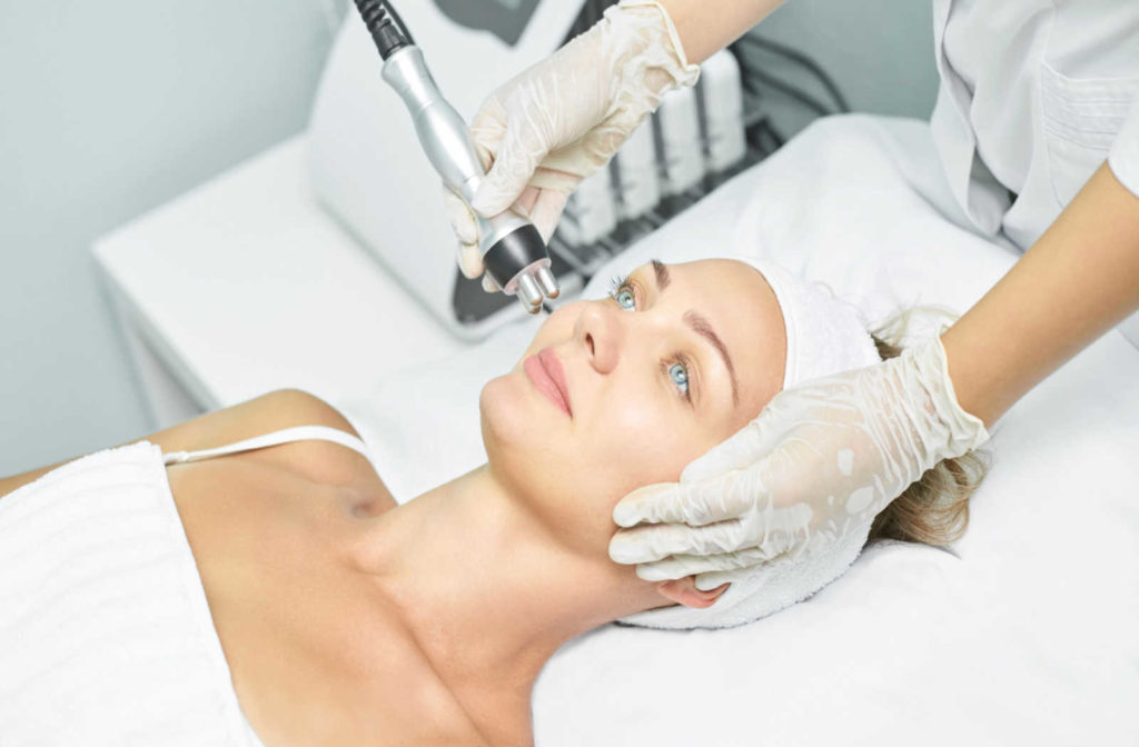 A woman undergoes radiofrequency treatment near her eyes.