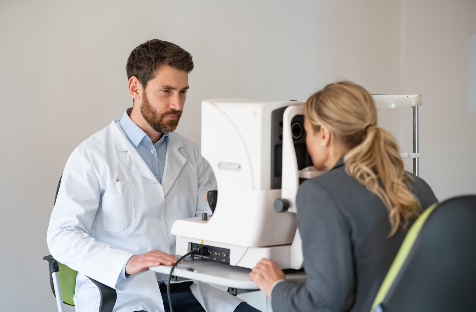 A woman having her eyes checked in her optometrist's office.